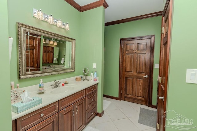 bathroom with tile patterned floors, baseboards, ornamental molding, and vanity