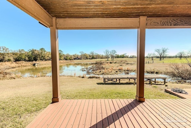 deck with a yard and a water view