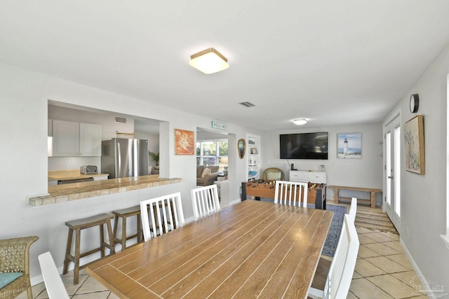 dining space with light tile patterned floors