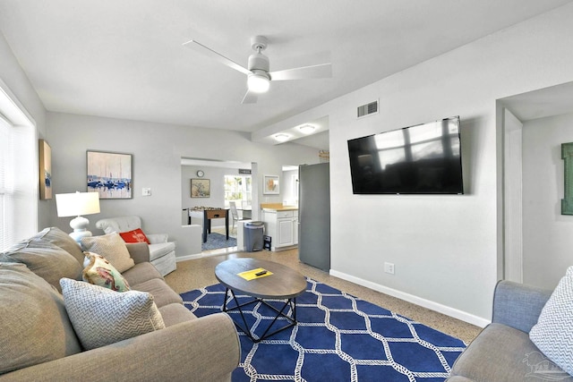 living room featuring ceiling fan and carpet floors