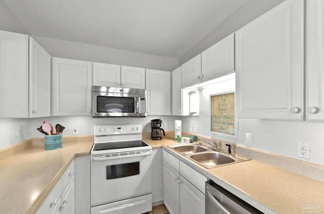 kitchen featuring white cabinets, sink, and appliances with stainless steel finishes