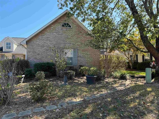 view of property exterior featuring brick siding