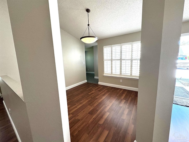 152 Mirabelle Cir, Pensacola, FL 32514 - unfurnished dining area featuring dark wood finished floors, baseboards, and a textured ceiling