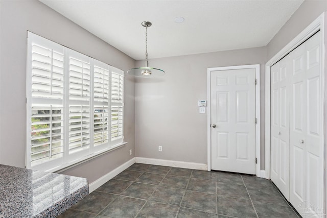 152 Mirabelle Cir, Pensacola, FL 32514 - unfurnished dining area with baseboards and dark tile patterned floors