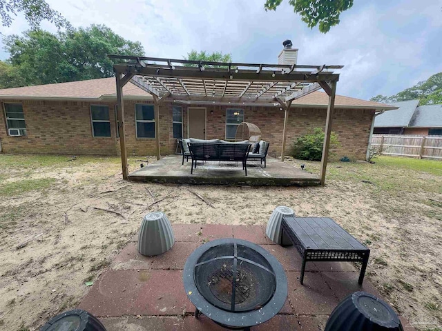 rear view of house with fence, a pergola, brick siding, a chimney, and a patio