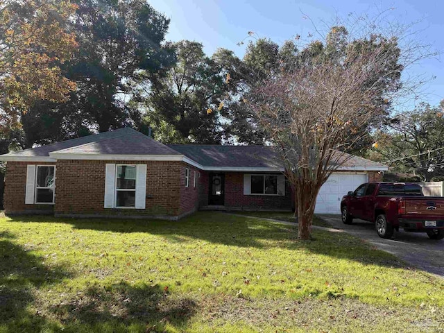 single story home with a garage and a front lawn