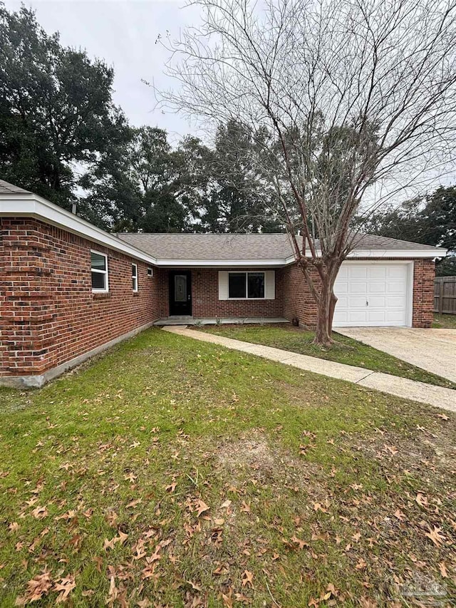 single story home with a garage and a front lawn