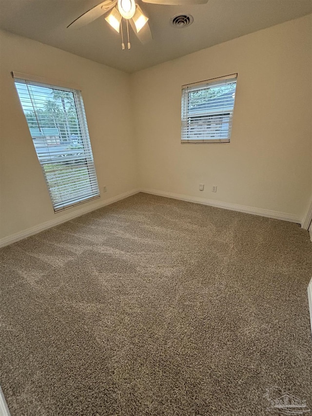 empty room with ceiling fan and carpet floors