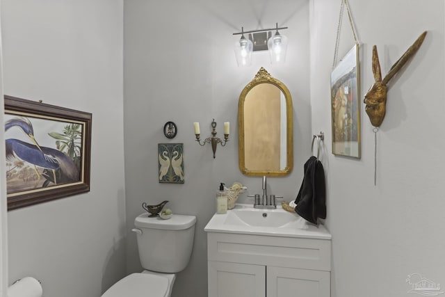 bathroom featuring toilet and vanity