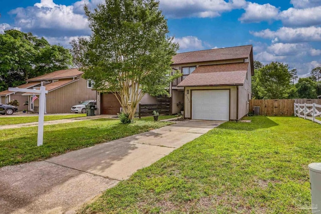 view of front of house featuring driveway, fence, a shingled roof, and a front yard