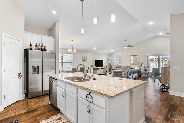 kitchen with white cabinetry, lofted ceiling, sink, a kitchen island with sink, and stainless steel appliances