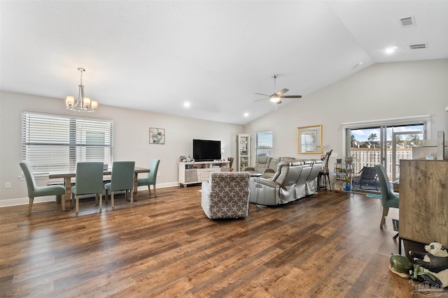 living room with dark wood-type flooring, lofted ceiling, and a healthy amount of sunlight