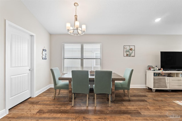 dining room with an inviting chandelier and dark hardwood / wood-style floors