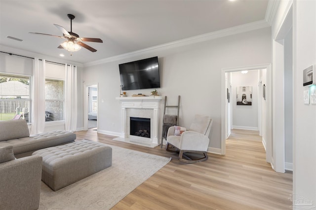 9938 Suwanee Ln, Pensacola, FL 32526 - living room with ornamental molding, a fireplace, ceiling fan, light wood-style flooring, and baseboards