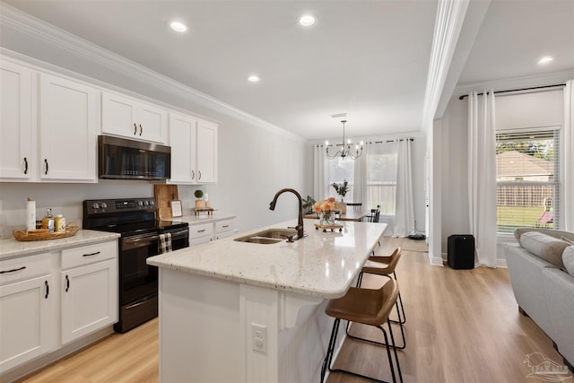 9938 Suwanee Ln, Pensacola, FL 32526 - kitchen with stainless steel microwave, black range with electric stovetop, ornamental molding, a sink, and light wood-type flooring