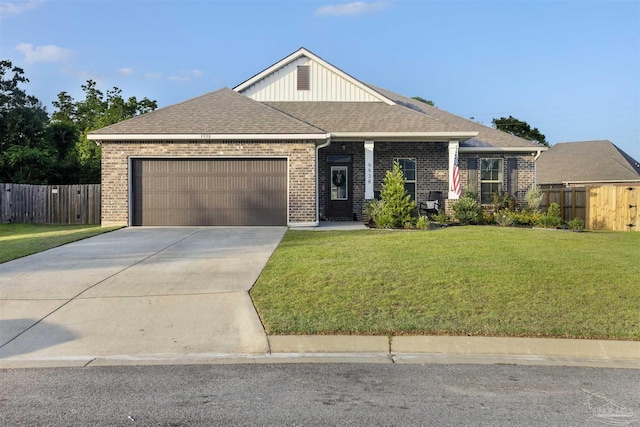 9938 Suwanee Ln, Pensacola, FL 32526 - craftsman inspired home featuring a garage, brick siding, driveway, and roof with shingles