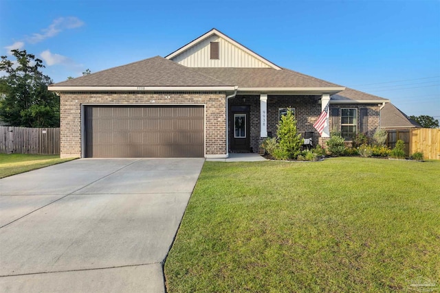 9938 Suwanee Ln, Pensacola, FL 32526 - view of front of house with brick siding, a garage, concrete driveway, board and batten siding, and roof with shingles