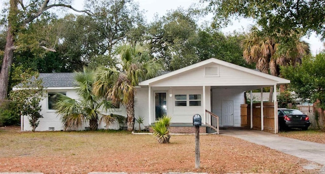 view of front facade with a front yard and a carport