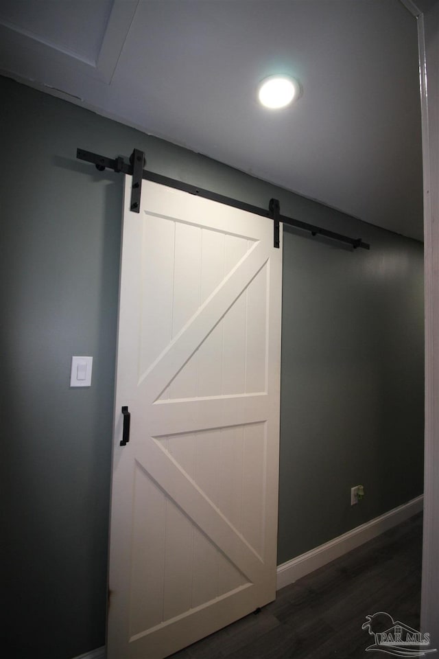 room details featuring wood-type flooring and a barn door