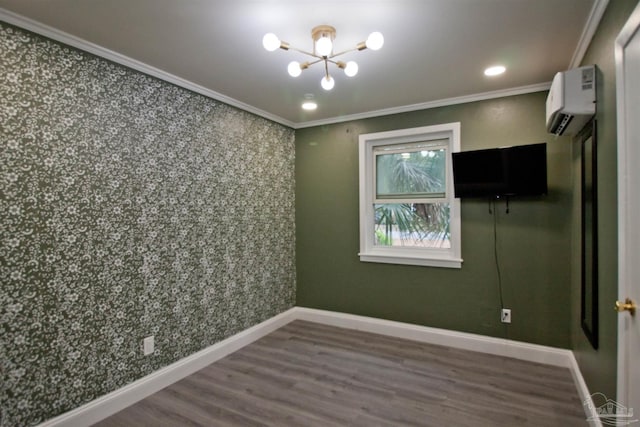 unfurnished room featuring ornamental molding, an AC wall unit, dark wood-type flooring, and a notable chandelier