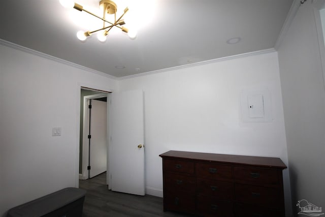 bedroom featuring an inviting chandelier, ornamental molding, and dark hardwood / wood-style floors