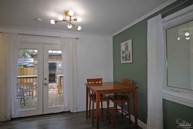 dining area featuring french doors, crown molding, dark hardwood / wood-style flooring, and a chandelier