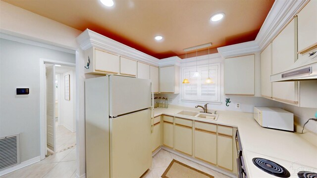 kitchen with light countertops, visible vents, recessed lighting, a sink, and freestanding refrigerator