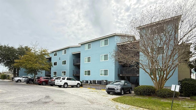 view of building exterior featuring uncovered parking