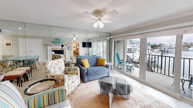 living room with a ceiling fan and a textured ceiling