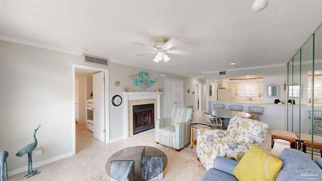 living room featuring a ceiling fan, ornamental molding, and visible vents