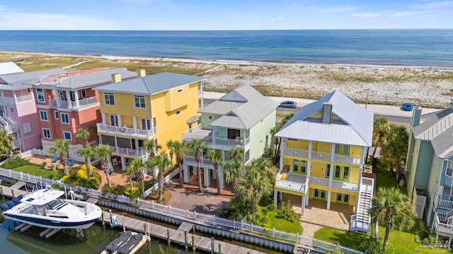 birds eye view of property featuring a water view and a view of the beach