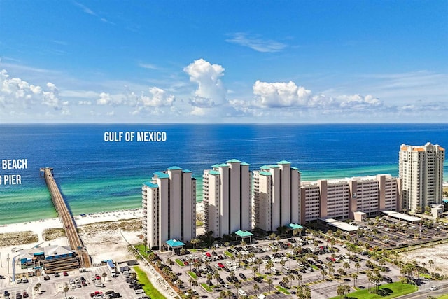 birds eye view of property with a water view and a beach view