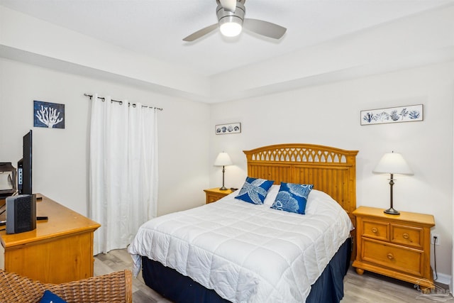 bedroom with ceiling fan and light hardwood / wood-style floors