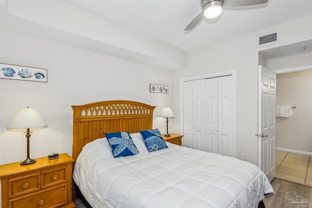 bedroom with ceiling fan, a closet, and light wood-type flooring