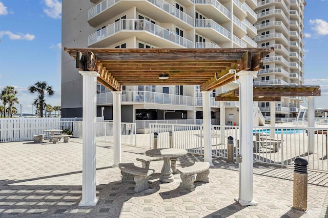 view of patio / terrace featuring a balcony and a community pool