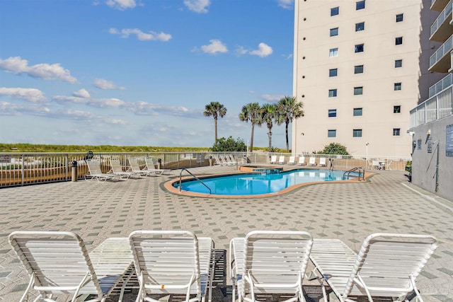 view of swimming pool with a patio