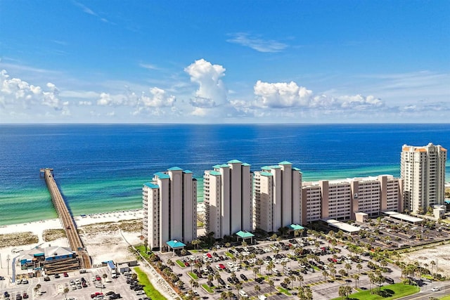 drone / aerial view featuring a beach view and a water view