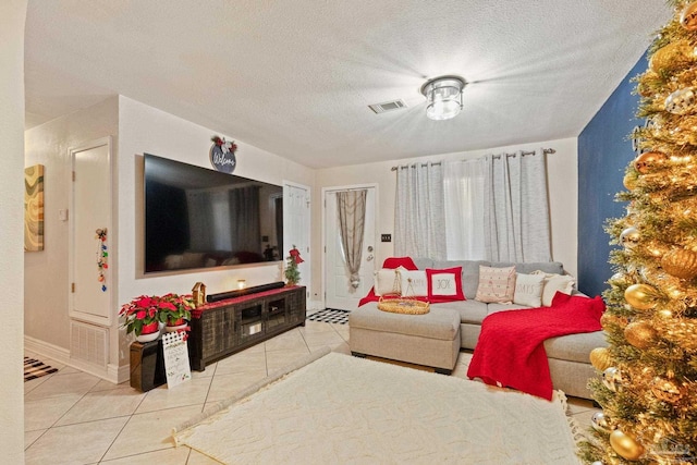 living room with light tile patterned floors and a textured ceiling