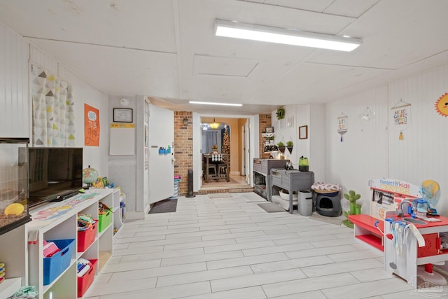 recreation room featuring wooden walls