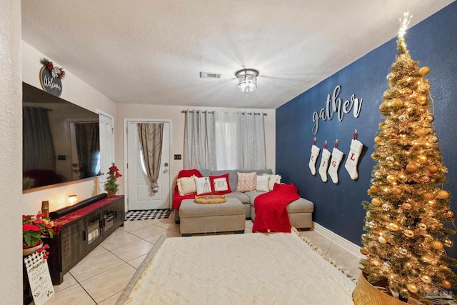 tiled living room featuring a textured ceiling