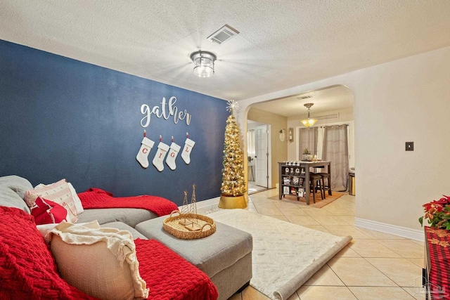 living room featuring a textured ceiling and tile patterned floors