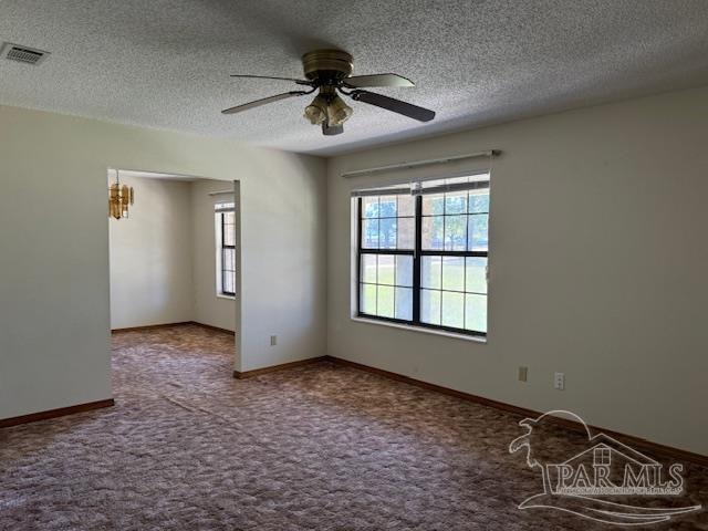 carpeted spare room featuring a textured ceiling and ceiling fan