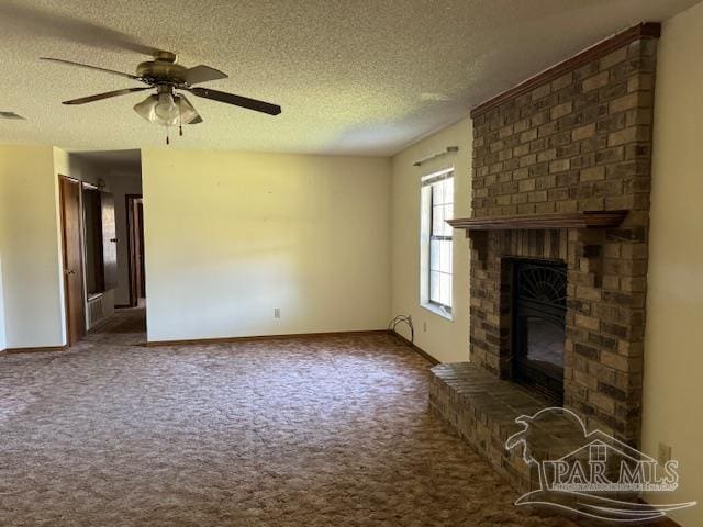 unfurnished living room with a textured ceiling, ceiling fan, dark carpet, and a fireplace