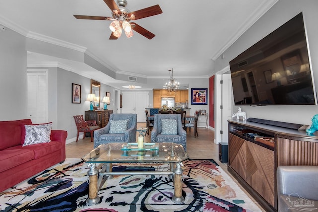 living area with light tile patterned flooring, crown molding, baseboards, and ceiling fan with notable chandelier