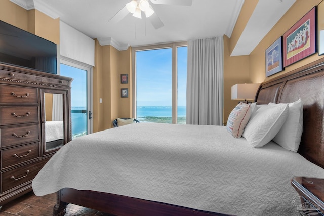 bedroom featuring crown molding, a water view, ceiling fan, dark wood finished floors, and access to outside