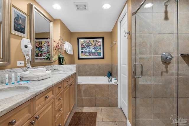bathroom with visible vents, tile patterned flooring, a shower stall, a garden tub, and vanity