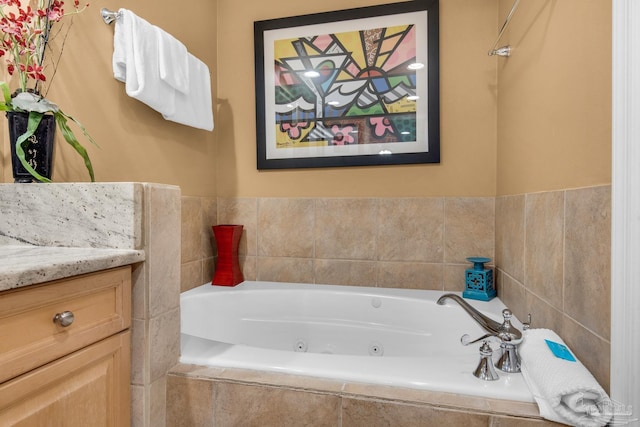 full bath with vanity and a whirlpool tub