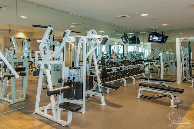 exercise room with visible vents and recessed lighting
