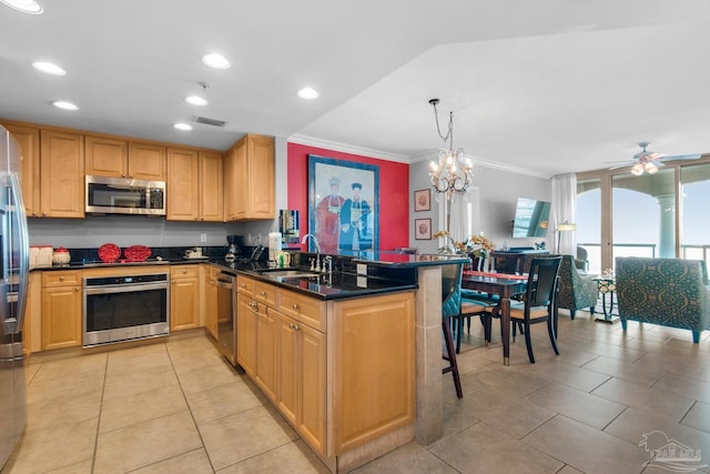 kitchen featuring stainless steel appliances, visible vents, ornamental molding, a sink, and a peninsula