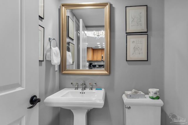 half bath featuring a sink and toilet